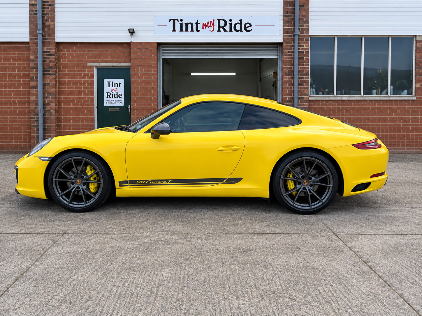 Yellow Porsche 911 outside the Tint My Ride workshop